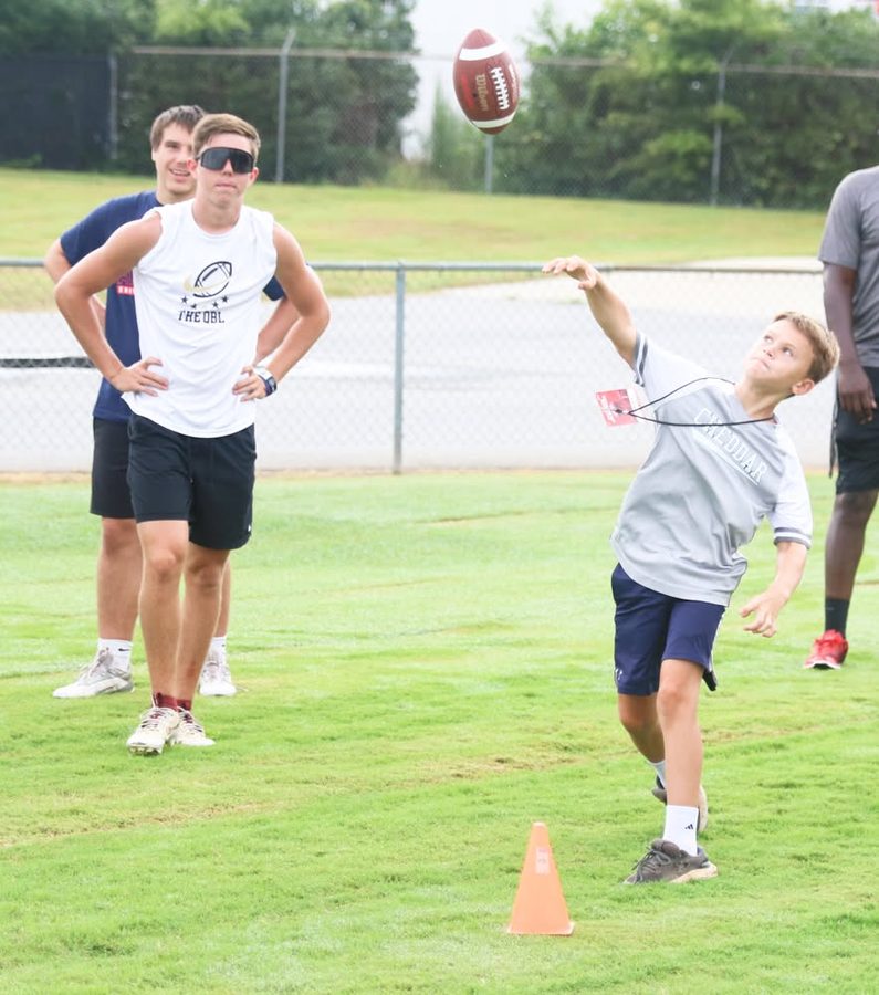 Camper throwing a pass during the QB station