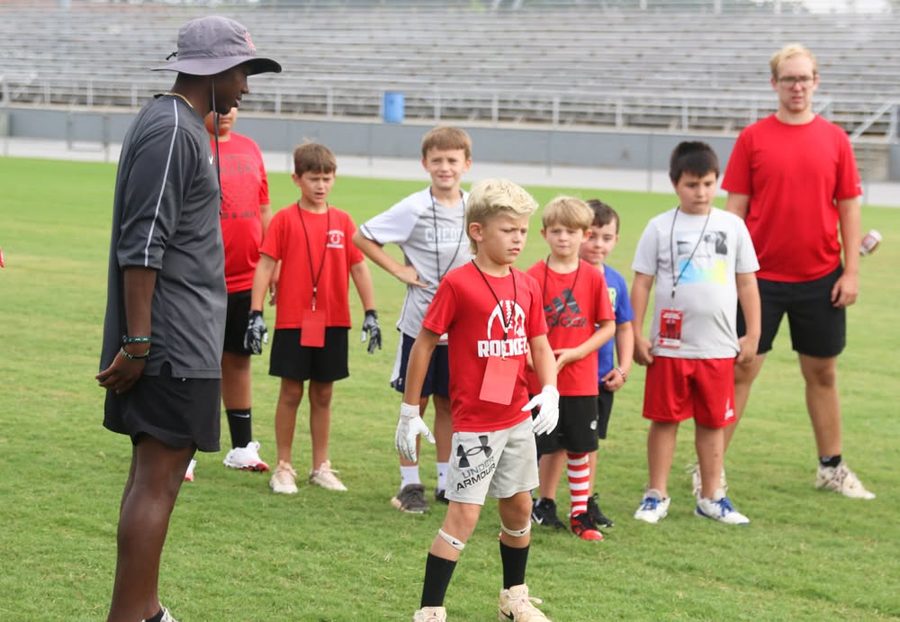 Coaches instructing a group of campers