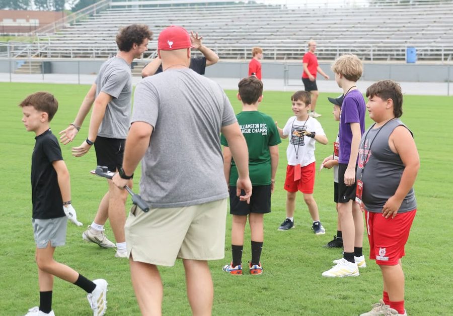 Campers gathered with varsity player coaches