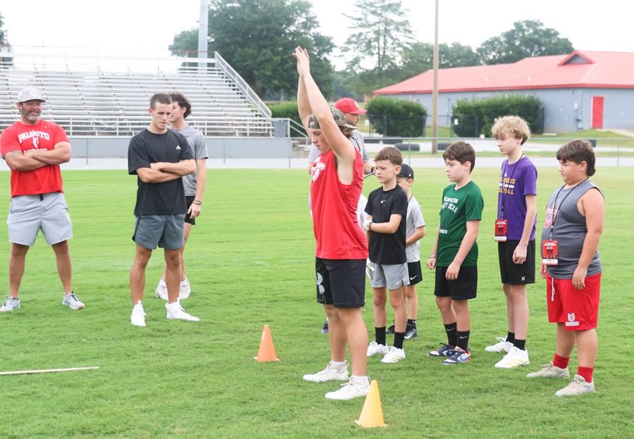 Coach demonstrating a drill at the cones
